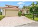 Luxury home with a brick driveway and landscaping at 4561 Murcia Blvd # 13, Sarasota, FL 34238