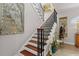 Grand staircase with ornate railing and artwork at 4561 Murcia Blvd # 13, Sarasota, FL 34238