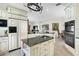 Island kitchen with granite countertops and ample storage at 4561 Murcia Blvd # 13, Sarasota, FL 34238
