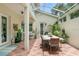 Covered patio with dining table and lush greenery at 4561 Murcia Blvd # 13, Sarasota, FL 34238