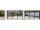 Interior view showcasing large sliding doors opening to the pool and canal at 4915 Primrose Path, Sarasota, FL 34242