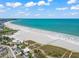 Stunning aerial view of a pristine beach with clear water at 4915 Primrose Path, Sarasota, FL 34242