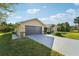 Attached garage with a dark brown door and a long driveway at 510 Border St, Port Charlotte, FL 33953