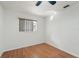 Simple bedroom featuring wood-look floors and window with blinds at 510 Border St, Port Charlotte, FL 33953