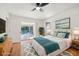 Bright bedroom with pool view, ceiling fan, and wood floors at 510 Border St, Port Charlotte, FL 33953