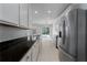 Modern kitchen with dark countertops, white cabinets, and stainless steel appliances at 5331 98Th E Ave, Parrish, FL 34219