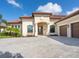 Two-story house with a tile roof and a paved driveway at 5553 Mulligan Way, Bradenton, FL 34211