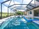 Inviting pool area with a covered patio and spa at 5553 Mulligan Way, Bradenton, FL 34211