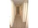 Bright hallway with neutral wall tones and carpet flooring at 5701 Soldier Cir # 104, Sarasota, FL 34233