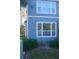 Building exterior showcasing blue siding, a large window, and landscaping at 5701 Soldier Cir # 104, Sarasota, FL 34233