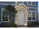 Two-story house with white door and blue siding at 5701 Soldier Cir # 104, Sarasota, FL 34233