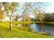 Serene lakefront view with trees and homes at 5701 Soldier Cir # 104, Sarasota, FL 34233