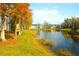 Community lakefront view with fall foliage at 5701 Soldier Cir # 104, Sarasota, FL 34233