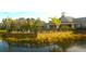 Community clubhouse and pool area with lake view at 5701 Soldier Cir # 104, Sarasota, FL 34233