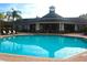 Relaxing community pool area with surrounding patio furniture at 5701 Soldier Cir # 104, Sarasota, FL 34233