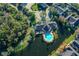 Aerial view showcasing a community pool and clubhouse near a lake at 5701 Soldier Cir # 104, Sarasota, FL 34233