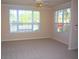Large living room with neutral walls, carpet, and multiple windows at 5701 Soldier Cir # 104, Sarasota, FL 34233