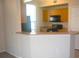 Modern kitchen with wood cabinets, black appliances, and a breakfast bar at 5701 Soldier Cir # 104, Sarasota, FL 34233