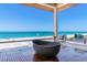 Stunning balcony with modern tub overlooking the ocean and sandy beach at 5861 Gulf Of Mexico Dr, Longboat Key, FL 34228