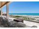 Outdoor seating on a balcony with ocean views of the beach at 5861 Gulf Of Mexico Dr, Longboat Key, FL 34228