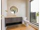 Chic bathroom featuring modern vanity, toilet, and decorative mirror at 5861 Gulf Of Mexico Dr, Longboat Key, FL 34228