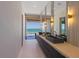 Modern bathroom with double vanity, trough sinks, and floor-to-ceiling mirrors at 5861 Gulf Of Mexico Dr, Longboat Key, FL 34228