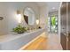 Modern bathroom with stone accents, a double sink, and stylish lighting at 5861 Gulf Of Mexico Dr, Longboat Key, FL 34228