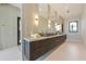 Sleek bathroom with double vanity, trough sinks, and modern fixtures at 5861 Gulf Of Mexico Dr, Longboat Key, FL 34228