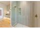 Modern bathroom featuring a glass enclosed shower and bright vanity with gold hardware at 5861 Gulf Of Mexico Dr, Longboat Key, FL 34228