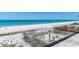 Gorgeous beach view from the home's balcony with white sand and turquoise water at 5861 Gulf Of Mexico Dr, Longboat Key, FL 34228