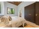 Serene bedroom with wood ceiling, hardwood floors, and ensuite bath and closet at 5861 Gulf Of Mexico Dr, Longboat Key, FL 34228
