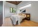 Cozy bedroom featuring a wood ceiling, hardwood floors, and a window overlooking tropical greenery at 5861 Gulf Of Mexico Dr, Longboat Key, FL 34228