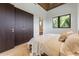Bright bedroom with wood ceiling, hardwood floors, and ensuite bath and closet at 5861 Gulf Of Mexico Dr, Longboat Key, FL 34228