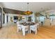 Elegant dining area with a statement chandelier and open access to the living spaces at 5861 Gulf Of Mexico Dr, Longboat Key, FL 34228