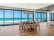 Stunning dining room with ocean views and modern light fixture at 5861 Gulf Of Mexico Dr, Longboat Key, FL 34228