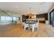 Open-concept living and dining area featuring modern decor and a grand staircase at 5861 Gulf Of Mexico Dr, Longboat Key, FL 34228