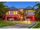 Stunning exterior of a luxury home with a circular driveway and a well-manicured lawn at 5861 Gulf Of Mexico Dr, Longboat Key, FL 34228