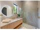 Modern bathroom with a glass shower, floating vanity, and marble tile at 5861 Gulf Of Mexico Dr, Longboat Key, FL 34228