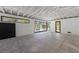 Spacious garage area featuring a concrete floor, high ceilings, and natural light from surrounding windows at 5861 Gulf Of Mexico Dr, Longboat Key, FL 34228
