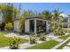 Detached one-car garage boasting modern design and lush landscaping at 5861 Gulf Of Mexico Dr, Longboat Key, FL 34228