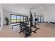Well-equipped gym with a weight rack, barbell, and floor-to-ceiling windows showcasing beautiful ocean views at 5861 Gulf Of Mexico Dr, Longboat Key, FL 34228