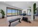 Large gym featuring weightlifting equipment and scenic views through expansive sliding glass doors at 5861 Gulf Of Mexico Dr, Longboat Key, FL 34228
