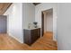 Hallway with wet bar, stylish cabinetry, and hardwood flooring at 5861 Gulf Of Mexico Dr, Longboat Key, FL 34228
