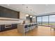 Open kitchen featuring an island with bar seating, custom cabinets, and ocean views at 5861 Gulf Of Mexico Dr, Longboat Key, FL 34228
