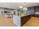Modern kitchen featuring an island, custom cabinets, stainless steel appliances and wood flooring at 5861 Gulf Of Mexico Dr, Longboat Key, FL 34228