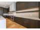 Modern kitchen featuring custom cabinets, stone countertops, and stainless steel appliances at 5861 Gulf Of Mexico Dr, Longboat Key, FL 34228