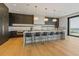 Open kitchen featuring an island with bar seating, custom cabinets, and ocean views at 5861 Gulf Of Mexico Dr, Longboat Key, FL 34228