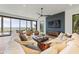 Bright living room with large sofa, ocean views and sleek ceiling fan at 5861 Gulf Of Mexico Dr, Longboat Key, FL 34228