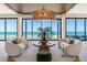 Bright living room with ocean views, stylish seating, and natural light at 5861 Gulf Of Mexico Dr, Longboat Key, FL 34228