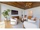 Bright living room featuring wood-paneled ceiling, modern furnishings, and neutral color palette at 5861 Gulf Of Mexico Dr, Longboat Key, FL 34228